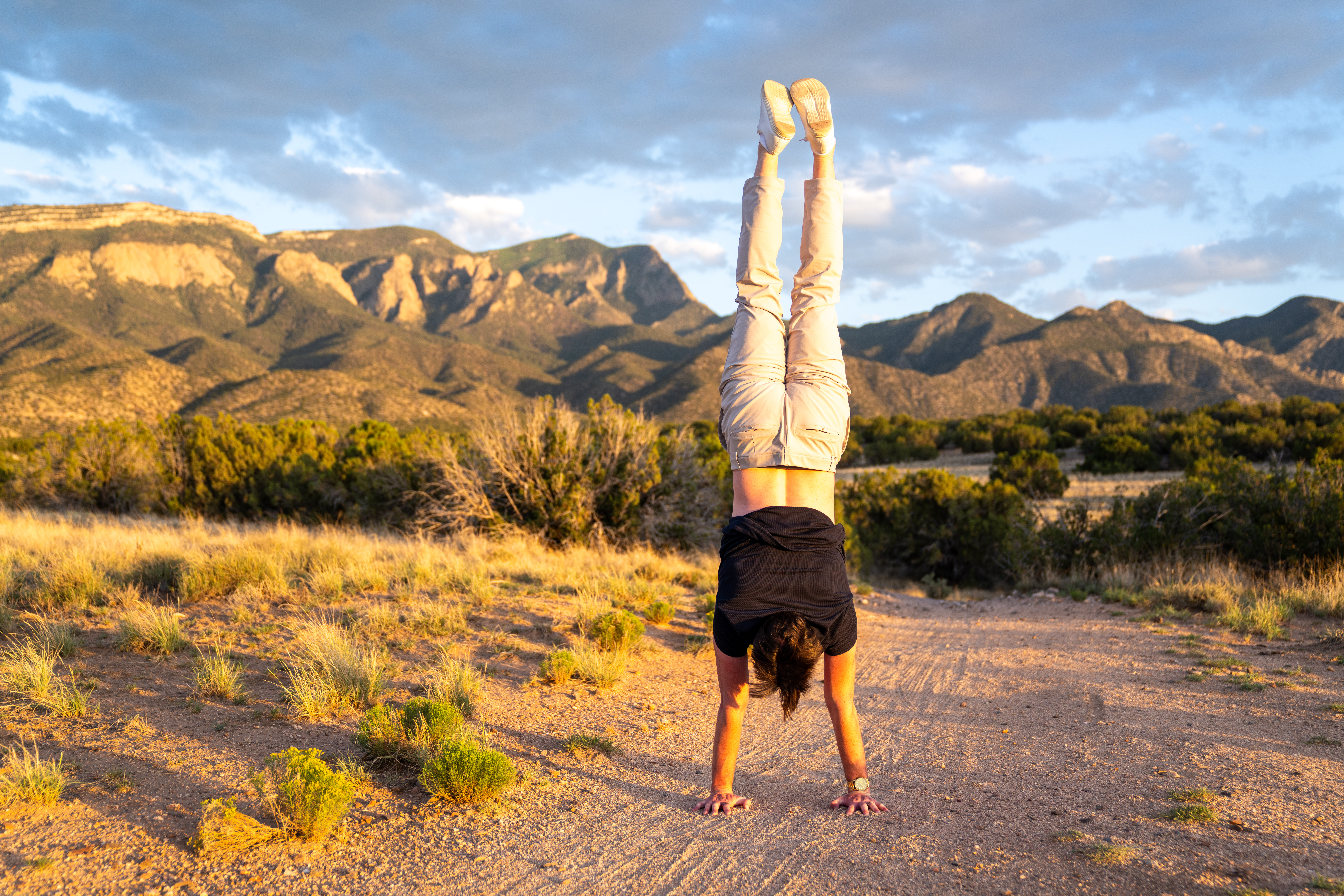 Handstand with Sandia Mountains backdrop